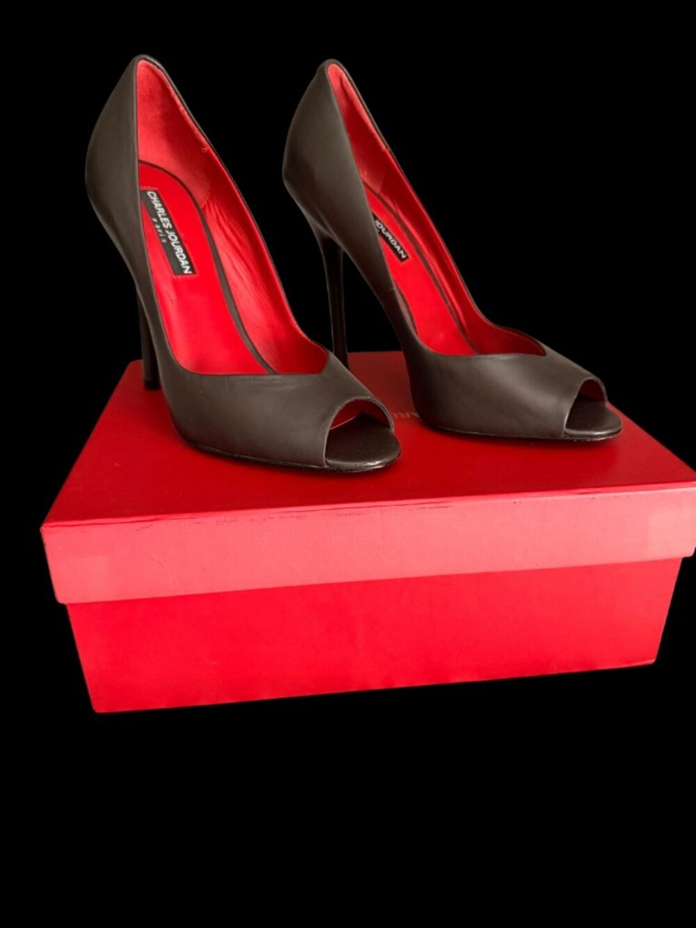 Charles Jourdan black leather peep-toe pumps designed with a smooth leather uppe